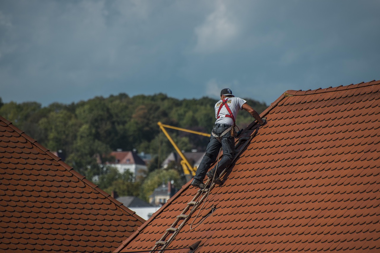 Professional roofing contractor working on residential roof repair