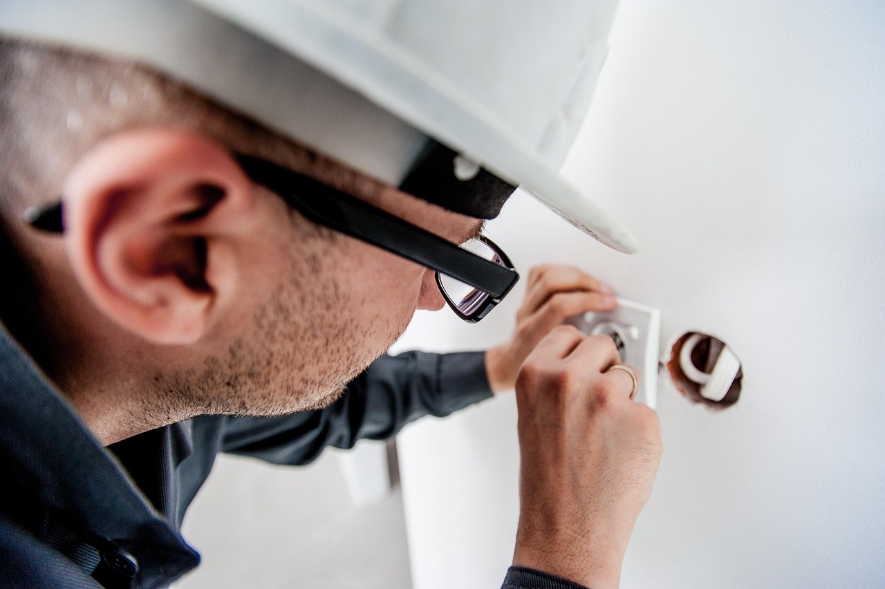 Building inspector examining structure with clipboard and safety equipment